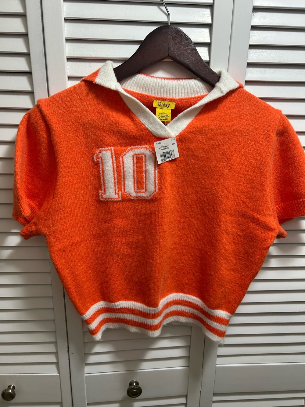 Junior Daisy Bright Orange Short-Sleeve Knit Polo with White Trim and '10' Patch